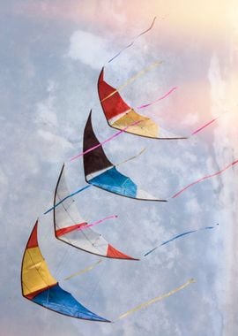 colorful kites flying in single file in the sky