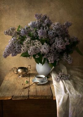 Still life with dishes and fresh lilac.