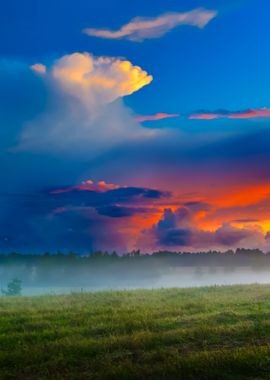 Sunset Over A Misty Field