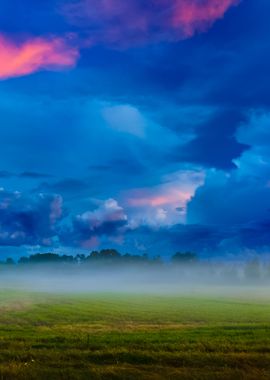 Sunset Over A Misty Field