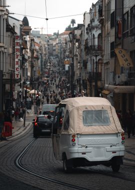 White Tuk Tuk on Cobblestone Street in Porto