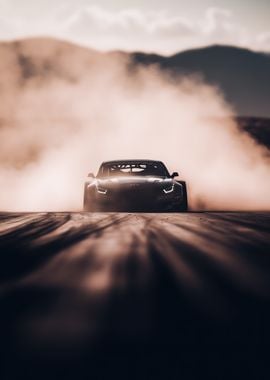 black racing car speeding out of a cloud of smoke