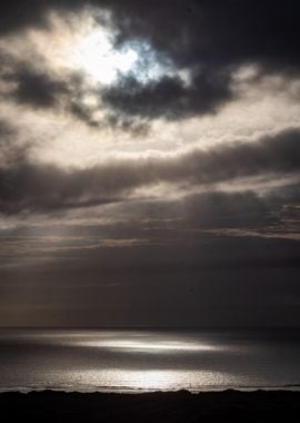 Sun Through Clouds Over Sea