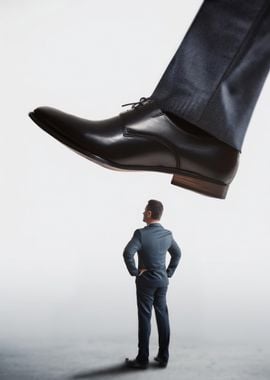 Giant Foot Over Businessman