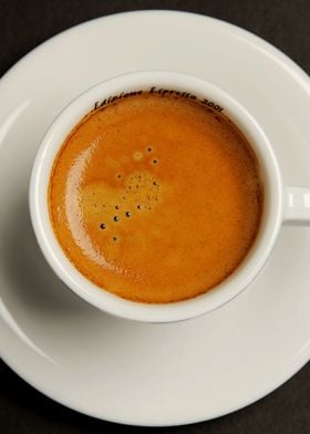 an espresso coffee on dark background photographed from ... 