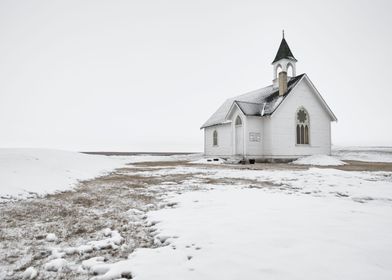 A church in the prairies on a snowy day
