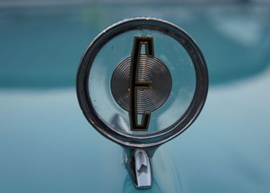 Close up of a hood ornament on an antique Edsel.