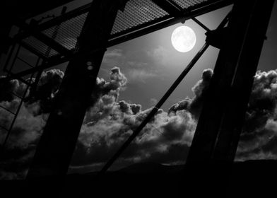 structures of industry against the full moon sky