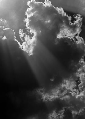 A sunbeam finds its way through the clouds... in black  ... 