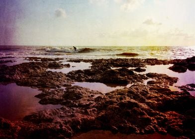 surfer in the rocks