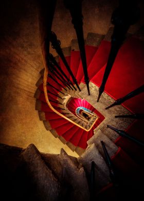 Spiral staircase with red carpet