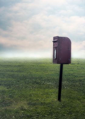 red letterbox on a field