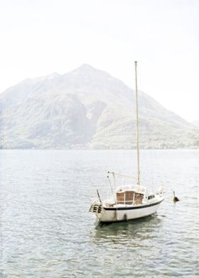 Minimalist Sail Boat on Lake with Mountain. Photographe ... 