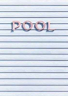 the word pool written on a white wooden wall