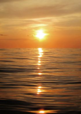 Sun setting over calm waters