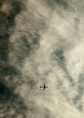plane in cloudy sky