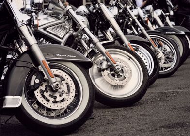 a row of motorcycle's front tyres