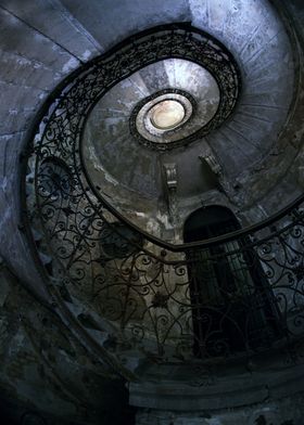 Old forgotten spiral staircase in blue tones