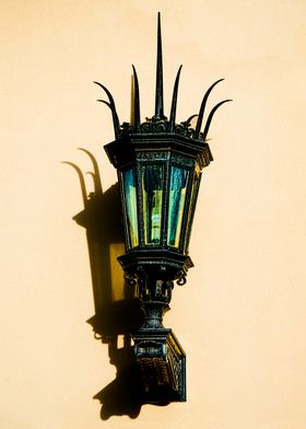 Light and Shadow, an antique gaslamp mounted on a wall  ... 