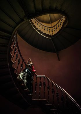 Young girl wearing tudor dress in spiral staircase