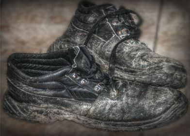 a hdr image of a pair of old work boots in mono