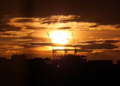 Glasgow cranes silhouetted against the rising sun
