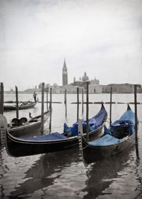 Black and white Venetian view of two blue gondolas with ... 