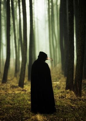 Man in cape and dr plague mask in the autumnal forest
