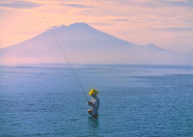 Fisher in Kuta-Bali with Volcano Agung as skyline