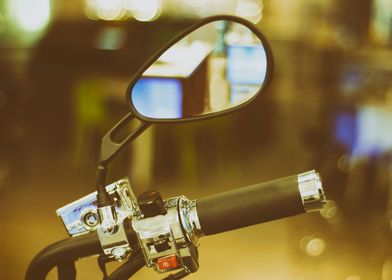 Photograph of a motorcycle handlebar and mirror