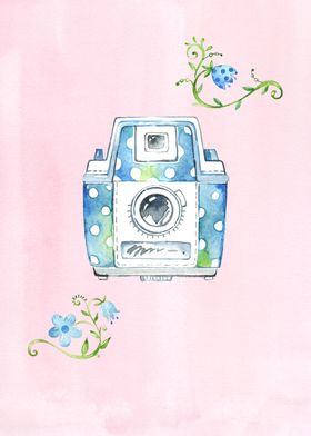 A blue vintage camera in watercolour with white dots an ... 