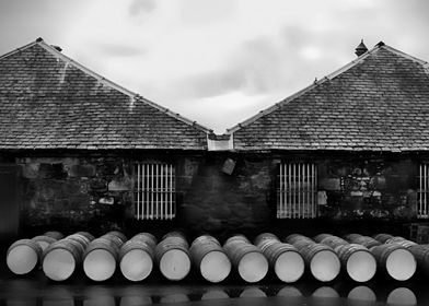 Old used whiskey barrels at the Balblair Distillery in  ... 