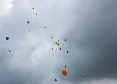 Baloons rising into the dark sky