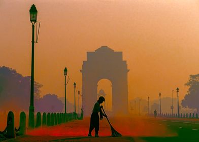 Man sweepinng in front of India`s Gate in New Delhi