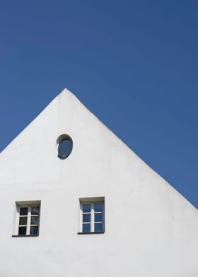 A Simple white house against a blue sky