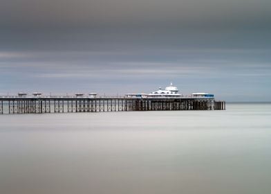 Calm sea around the Victorian Llandudno pier in North W ... 