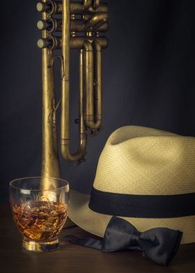 Vertically standing trumpet with a hat, drink and neck  ... 