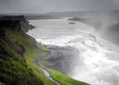 Mist rises over the canyon and tourists at Gullfoss in  ... 