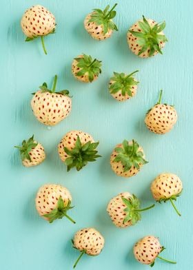 Fresh pineberries on a turquoise wooden table