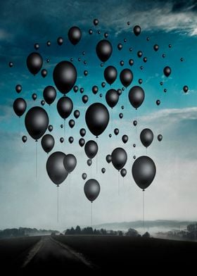 landscape with a sky full of black balloons