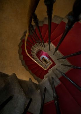 Spiral staircase with red carpet