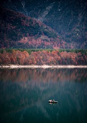 Fishing boat on lake in autum.