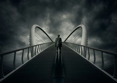 man standing on bridge