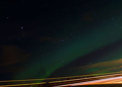 The aurora over top of a highway, got some taillights t ... 