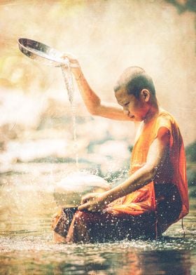 Vintage composition of a boy washing pots in river.