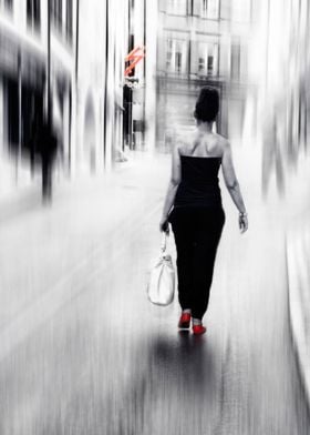 a beautiful woman walking on a street in red shoes