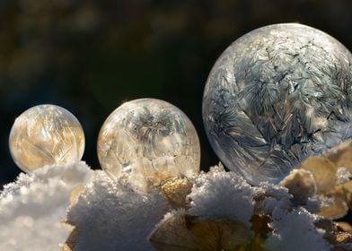 Trio of frozen soap bubbles with unique icy crystalline ... 
