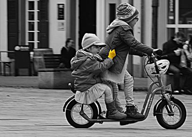 Two youngsters having fun on a scooter