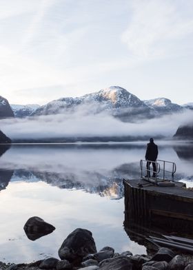 Man gazing out onto Hardangerfjord in Norway.