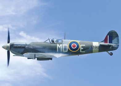 Spitfire AB910 against a clear sky.